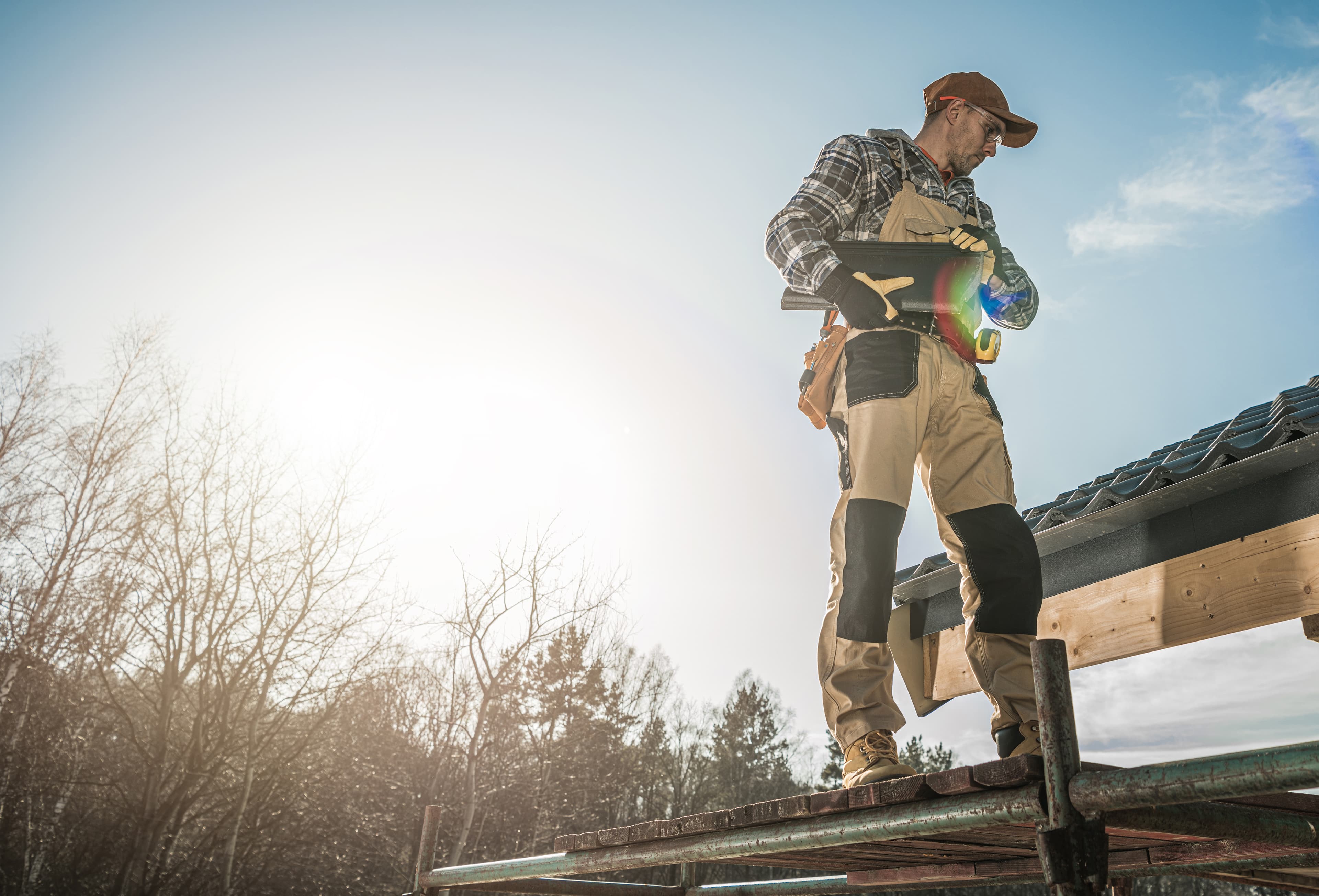 Roofer performing an on-site inspection of a residential St. Louis home.