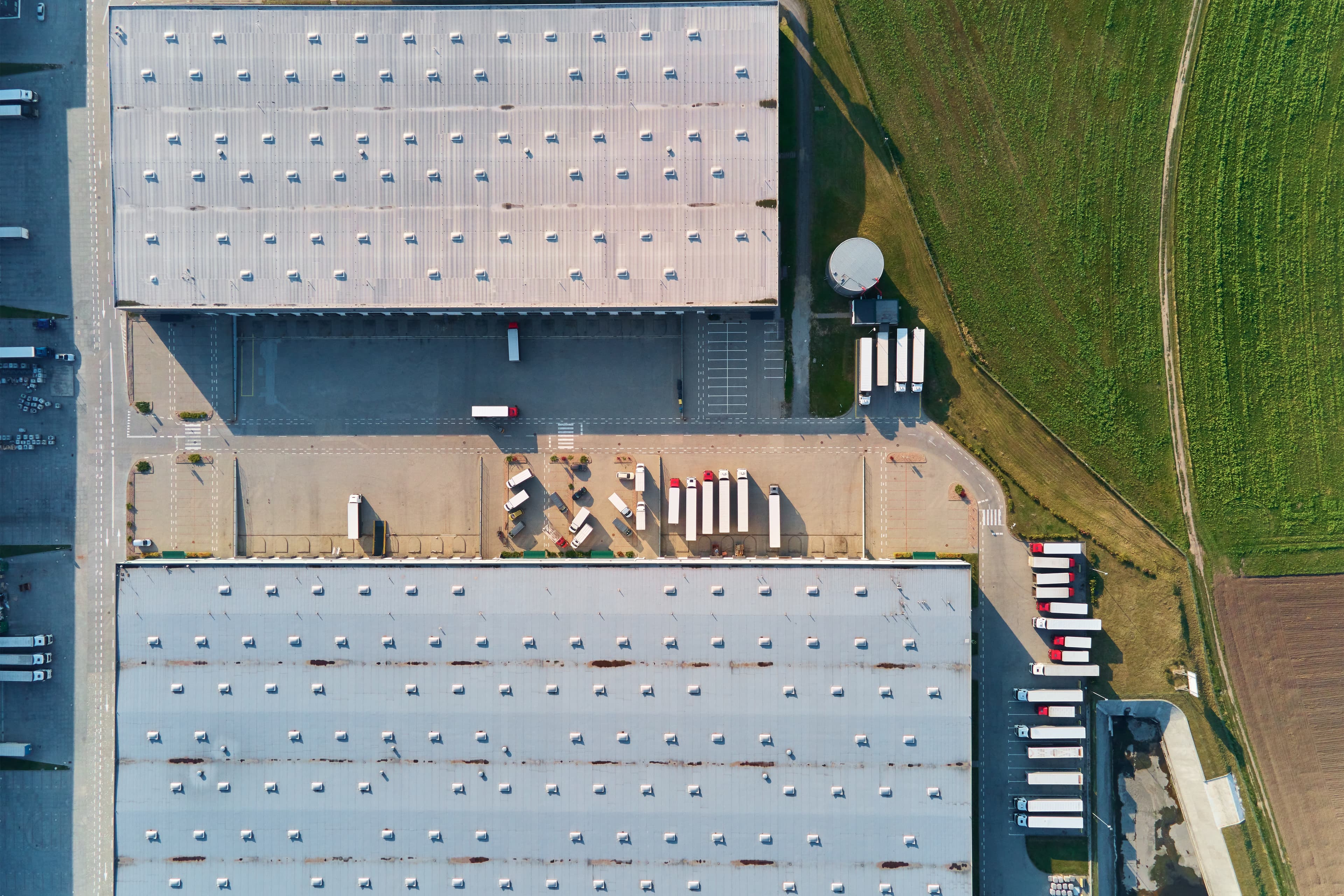 Aerial view of a large industrial flat roof on a warehouse facility.